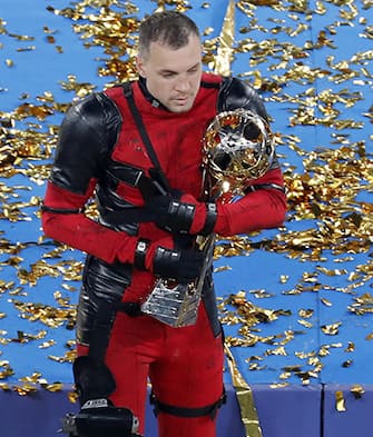 epa09174562 Zenit St. Petersburg's Artem Dzyuba wearing a Deadpool costume holds the trophy after winning the Russian Premier League title following their match against Lokomotiv Moscow in St. Petersburg, Russia, 02 May 2021.  EPA/ANATOLY MALTSEV