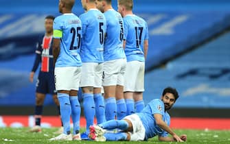 MANCHESTER, ENGLAND - MAY 04: Ilkay Gundogan of Manchester City lies down behind the City defensive wall during the UEFA Champions League Semi Final Second Leg match between Manchester City and Paris Saint-Germain at Etihad Stadium on May 4, 2021 in Manchester, United Kingdom. Sporting stadiums around the UK remain under strict restrictions due to the Coronavirus Pandemic as Government social distancing laws prohibit fans inside venues resulting in games being played behind closed doors. (Photo by Simon Stacpoole/Offside/Offside via Getty Images)