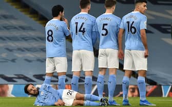 Manchester City's Bernardo Silva lies down behind the defensive wall during the Premier League match at the Etihad Stadium, Manchester. Picture date: Saturday February 13, 2021. (Photo by Rui Vieira/PA Images via Getty Images)