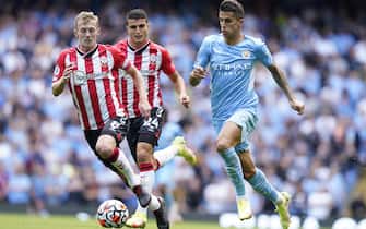 epa09475234 Joao Cancelo (R) of Manchester City in action against Southampton players James Ward-Prowse (L) and Mohamed Elyounoussi (C) during the English Premier League soccer match between Manchester City and Southampton FC in Manchester, Britain, 18 September 2021.  EPA/Andrew Yates EDITORIAL USE ONLY. No use with unauthorized audio, video, data, fixture lists, club/league logos or 'live' services. Online in-match use limited to 120 images, no video emulation. No use in betting, games or single club/league/player publications
