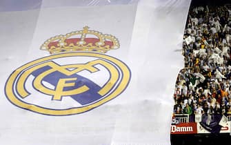 Supporters of Real Madrid are seen in front of a huge banner with the logo of their team at Mestalla stadium in Valencia, eastern Spain, prior to the King's Cup soccer final between FC Barcelona and Real Madrid, 16 April 2014. EFE/Alberto Estevez 