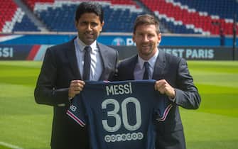 epa09409578 Paris Saint-Germain's president Nasser Al-Khelaifi (L) and Argentinian striker Lionel Messi pose with his new PSG jersey after his press conference as part of his official presentation at the Parc des Princes stadium, in Paris, France, 11 August 2021. Messi arrived in Paris on 09 August and signed a contract with French soccer club Paris Saint-Germain.  EPA/CHRISTOPHE PETIT TESSON