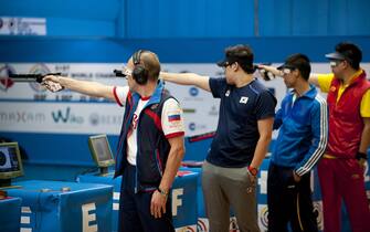 (FromL) Russian shooter Vladimir Gontcharov, Korean shooter Jin Jong-oh, Vietnamese shooter Tran Quoc Cuong, and Chinese shooter Pang Wei compete in the 10m Air Pistol Men final during the 51st ISSF World Championship in Las Gabias, near Granada on September 11, 2014.   AFP PHOTO/ JORGE GUERRERO        (Photo credit should read Jorge Guerrero/AFP via Getty Images)
