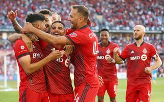 TORONTO, ON - JULY 23:  Jonathan Osorio #21 (L) of Toronto FC celebrates a goal with Lorenzo Insigne #24, Jesus Jimenez #9, Federico Bernardeschi #10 and Domenico Criscito #44 in an MLS game against Charlotte FC at BMO Field on July 23, 2022 in Toronto, Ontario, Canada.  (Photo by Vaughn Ridley/Getty Images)