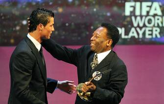 Portuguese football player Cristiano Ronaldo (L) is congratulated by Brazilian football legend Pele after recieving the FIFA world footballer of the year 2008 award on January 12, 2009 in Zurich. Ronaldo, who is also holder of the prestigious Ballon d'Or for the European Footballer of the Year, beat off competition from 2007 winner Kaka (Brazil), Lionel Messi (Argentina), Fernando Torres (Spain) and Xavi (Spain). AFP PHOTO / JOE KLAMAR (Photo credit should read JOE KLAMAR/AFP via Getty Images)