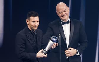 epa10494447 Argentinian soccer player Lionel Messi of Paris Saint-Germain FC with his the Best FIFA Men's Player Award next to FIFA President Gianni Infantino on stage during the The Best FIFA Football Awards 2022 ceremony in Paris, France, 27 February 2023.  EPA/YOAN VALAT