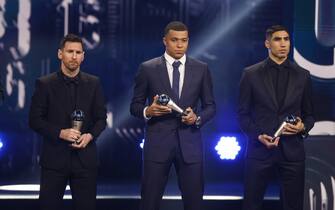 epa10494444 Argentinian soccer player Lionel Messi (L), French soccer player Kylian Mbappe (C) and Moroccan soccer player Achraf Hakimi (R) of Paris Saint-Germain FC with their Men’s World 11 Award on stage during the The Best FIFA Football Awards 2022 ceremony in Paris, France, 27 February 2023.  EPA/YOAN VALAT