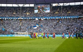 08 April 2023, Berlin: Soccer: Bundesliga, Hertha BSC - RB Leipzig, Matchday 27, Olympiastadion. Lettering in the stadium reads: "Ostkurve Hertha BSC against investors". With numerous banners and chants, fans in the Bundesliga protested against the possible partial sale of media rights to financial investors by the German Soccer League (DFL). Photo: Andreas Gora/dpa - IMPORTANT NOTE: In accordance with the requirements of the DFL Deutsche Fußball Liga and the DFB Deutscher Fußball-Bund, it is prohibited to use or have used photographs taken in the stadium and/or of the match in the form of sequence pictures and/or video-like photo series.