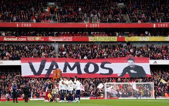 Arsenal and Leeds United players line up as fans hold up a banner for Arsenal manager Mikel Arteta during the Premier League match at the Emirates Stadium, London. Picture date: Saturday April 1, 2023.