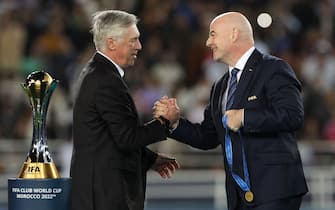 FIFA President Gianni Infantino (R) presents the medal to Real Madrid's Italian coach Carlo Ancelotti at the end of the FIFA Club World Cup final football match between Spain's Real Madrid and Saudi Arabia's Al-Hilal at the Prince Moulay Abdellah Stadium in Rabat on February 11, 2023. - Real Madrid lifted the Club World Cup for a record fifth time with a pulsating 5-3 win over Al-Hilal. (Photo by Fadel Senna / AFP) (Photo by FADEL SENNA/AFP via Getty Images)