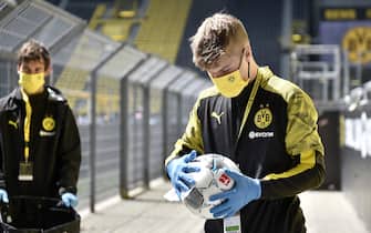 Ball boys disinfect the footballs prior the German first division Bundesliga football match BVB Borussia Dortmund v Schalke 04 on May 16, 2020 in Dortmund, western Germany as the season resumed following a two-month absence due to the novel coronavirus COVID-19 pandemic. (Photo by Martin Meissner / POOL / AFP) / DFL REGULATIONS PROHIBIT ANY USE OF PHOTOGRAPHS AS IMAGE SEQUENCES AND/OR QUASI-VIDEO (Photo by MARTIN MEISSNER/POOL/AFP via Getty Images)