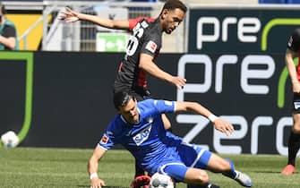 Hoffenheim's Austrian midfielder Florian Grillitsch (front) and Hertha Berlin's Brazilian forward Matheus Cunha vie for the ball during the German first division Bundesliga football match TSG 1899 Hoffenheim v Hertha Berlin on May 16, 2020 in Sinsheim south-western Germany as the season resumed following a two-month absence due to the novel coronavirus COVID-19 pandemic. (Photo by THOMAS KIENZLE / various sources / AFP) / DFL REGULATIONS PROHIBIT ANY USE OF PHOTOGRAPHS AS IMAGE SEQUENCES AND/OR QUASI-VIDEO (Photo by THOMAS KIENZLE/AFP via Getty Images)