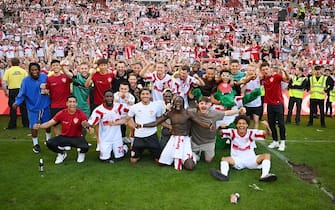 STUTTGART, GERMANY - MAY 14: VfB Stuttgart players celebrate with the fans on the pitch after their sides victory which results in VfB Stuttgart avoiding the relegation play offs in the Bundesliga match between VfB Stuttgart and 1. FC KÃ¶ln at Mercedes-Benz Arena on May 14, 2022 in Stuttgart, Germany. (Photo by Matthias Hangst/Getty Images)