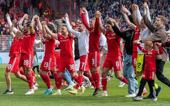 14 May 2022, Berlin: Soccer: Bundesliga, 1. FC Union Berlin - VfL Bochum, 34. matchday, An der Alten FÃ¶rsterei. Union Berlin players cheer after the victory. The Berlin Bundesliga club secures a place in the Europa League. Photo: Andreas Gora/dpa - IMPORTANT NOTE: In accordance with the requirements of the DFL Deutsche FuÃ ball Liga and the DFB Deutscher FuÃ ball-Bund, it is prohibited to use or have used photographs taken in the stadium and/or of the match in the form of sequence pictures and/or video-like photo series. (Photo by Andreas Gora/picture alliance via Getty Images)