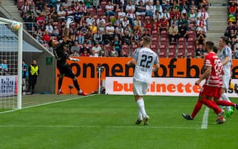 06 August 2022, Bavaria, Augsburg: Soccer, Bundesliga, FC Augsburg - SC Freiburg, Matchday 1, WWK Arena. Augsburg goalkeeper Rafal Gikiewicz (l) can only look behind the ball in the 0:2 goal. Photo: Stefan Puchner/dpa - IMPORTANT NOTE: In accordance with the requirements of the DFL Deutsche FuÃ ball Liga and the DFB Deutscher FuÃ ball-Bund, it is prohibited to use or have used photographs taken in the stadium and/or of the match in the form of sequence pictures and/or video-like photo series. (Photo by Stefan Puchner/picture alliance via Getty Images)
