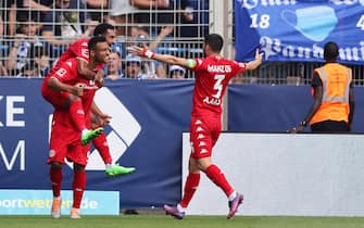 BOCHUM, GERMANY - AUGUST 06: Karim Onisiwo of 1.FSV Mainz 05 celebrates with teammates Angelo Fulgini and Aaron after scoring their side's first goal during the Bundesliga match between VfL Bochum 1848 and 1. FSV Mainz 05 at Vonovia Ruhrstadion on August 06, 2022 in Bochum, Germany. (Photo by Christof Koepsel/Getty Images)
