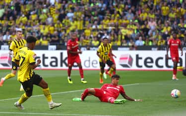 DORTMUND, GERMANY - AUGUST 06: Karim Adeyemi of Borussia Dortmund has a shot on goal, which is stopped on the line before Marco Reus ( obscured ) scores their side's first goal, during the Bundesliga match between Borussia Dortmund and Bayer 04 Leverkusen at Signal Iduna Park on August 06, 2022 in Dortmund, Germany. (Photo by Lars Baron/Getty Images)