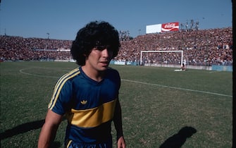 Soccer star Diego Maradona crosses a soccer field before a game. Maradona was the best and most popular soccer player in the world during the 1980s. Buenos Aires, Argentina. (Photo by Owen Franken/Corbis via Getty Images)