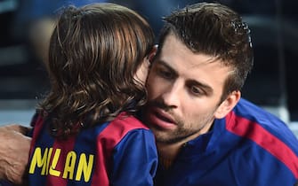 BARCELONA, SPAIN - OCTOBER 18:  Gerard Pique of FC Barcelona kisse to his son Milan during the La Liga match between FC Barcelona and SD Eibar at Camp Nou on October 18, 2014 in Barcelona, Spain.  (Photo by David Ramos/Getty Images)