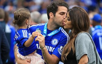 Cesc Fabregas of Chelsea kisses partner Daniella Semaan as he holds their daughter Lia (Photo by AMA/Corbis via Getty Images)