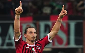AC Milan's Swedish forward Zlatan Ibrahimovic celebrates after scoring during their the Serie A football match between AC Milan and AS Roma at San Siro Stadium in Milan  on March 24, 2012. AFP PHOTO / GIUSEPPE CACACE        (Photo credit should read GIUSEPPE CACACE/AFP/GettyImages)