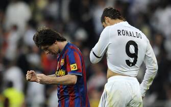 Barcelona's Argentinian forward Lionel Messi (L) celebrates after scoring next to Real Madrid's Portuguese forward Cristiano Ronaldo during the 'El Clasico' Spanish League football match Real Madrid against Barcelona at the Santiago Bernabeu stadium in Madrid, on April 10, 2010. AFP PHOTO/Dani POZO . (Photo credit should read Dani Pozo/AFP via Getty Images)