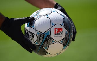 epa08425331 A ball boy wearing protective gloves holds an official Derbystar match ball prior to the Second Bundesliga match between Karlsruher SC and SV Darmstadt 98 at Wildparkstadion in Karlsruhe, Germany, 16 May 2020. The Bundesliga and Second Bundesliga are the first professional leagues to resume the season after the nationwide lockdown due to the ongoing Coronavirus (COVID-19) pandemic. All matches until the end of the season will be played behind closed doors.  EPA/MATTHIAS HANGST / GETTY IMAGES EUROPE POOL DFL regulations prohibit any use of photographs as image sequences and/or quasi-video.