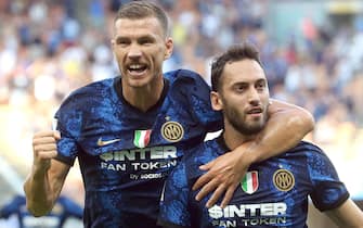 Inter Milan’s Hakan Calhanoglu (R) celebrates with his teammate  Edin Dzeko after scoring  goal of 2 to 0 during the Italian serie A soccer match between FC Inter  and Genoa at Giuseppe Meazza stadium in Milan, 21 August 2021.ANSA / MATTEO BAZZI