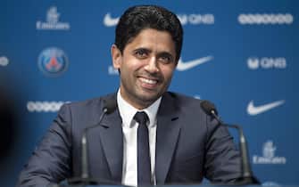 epa06083541 Paris Saint-Germain's chairman and CEO Nasser Al-Khelaifi smiles as new soccer player Dani Alves is presented during a news conference at the Parc des Princes stadium in Paris, France, 12 July 2017. Paris Saint Germain (PSG) signed a two-year contract with Alves who comes from Juventus on a free transfer.  EPA/IAN LANGSDON