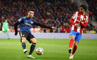 MADRID, SPAIN - FEBRUARY 23: Cristiano Ronaldo of Manchester United shoots at goal as Joao Felix of Atletico Madrid tries to block during the UEFA Champions League Round Of Sixteen Leg One match between Atletico Madrid and Manchester United at Wanda Metropolitano on February 23, 2022 in Madrid, Spain. (Photo by Chris Brunskill/Fantasista/Getty Images)