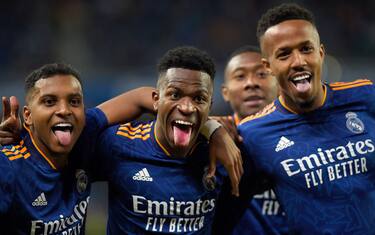 Real Madrid's Brazilian forward Vinicius Junior (C) celebrates scoring his team's first goal with Real Madrid's Brazilian forward Rodrygo (L) and Real Madrid's Brazilian defender Eder Militao during the Spanish League football match between Real Sociedad and Real Madrid CF at the Anoeta stadium in San Sebastian on December 4, 2021. (Photo by ANDER GILLENEA / AFP) (Photo by ANDER GILLENEA/AFP via Getty Images)