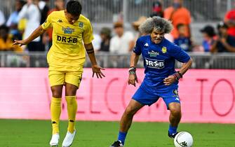 Colombian football player Carlos Valderrama (R) controls the ball during "The Beautiful Game" a celebrity football match at DRV PNK stadium in Fort Lauderdale, Florida on June 18, 2022. (Photo by CHANDAN KHANNA / AFP) (Photo by CHANDAN KHANNA/AFP via Getty Images)