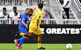 Brazilian football players Ronaldinho (R) and Roberto Carlos run after the ball during "The Beautiful Game" a celebrity football match at DRV PNK stadium in Fort Lauderdale, Florida on June 18, 2022. (Photo by CHANDAN KHANNA / AFP) (Photo by CHANDAN KHANNA/AFP via Getty Images)