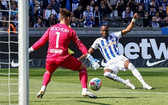 epa10640804 Hertha's Dodi Lukebakio (R) in action against Bochum's goalkeeper Manuel Riemann (L) during the German Bundesliga soccer match between Hertha BSC and VfL Bochum in Berlin, Germany, 20 May 2023.  EPA/CLEMENS BILAN (ATTENTION: The DFL regulations prohibit any use of photographs as image sequences and/or quasi-video.)