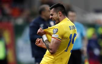 epa10547715 Romania's Andrei Burca celebrates after scoring the 2-0 during the UEFA EURO 2024 qualification match between Romania and Belarus in Bucharest, Romania, 28 March 2023.  EPA/Robert Ghement