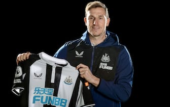 NEWCASTLE UPON TYNE, ENGLAND - JANUARY 13: Chris Wood poses for photographs holding a shirt at the Newcastle United Training Centre on January 13, 2022 in Newcastle upon Tyne, England. (Photo by Serena Taylor/Newcastle United via Getty Images)