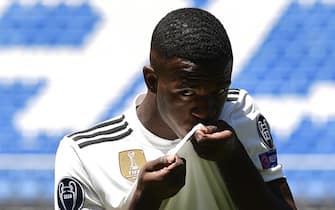 Real Madrid's new Brazilian forward Vinicius Junior kisses his new jersey during his official presentation at the Santiago Bernabeu Stadium in Madrid on July 20, 2018. (Photo by PIERRE-PHILIPPE MARCOU / AFP)        (Photo credit should read PIERRE-PHILIPPE MARCOU/AFP/Getty Images)