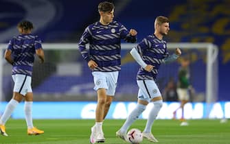 Chelsea's German midfielder Kai Havertz (C) and Chelsea's German striker Timo Werner (R) warm up ahead of the English Premier League football match between Brighton and Hove Albion and Chelsea at the American Express Community Stadium in Brighton, southern England on September 14, 2020. (Photo by Richard Heathcote / POOL / AFP) / RESTRICTED TO EDITORIAL USE. No use with unauthorized audio, video, data, fixture lists, club/league logos or 'live' services. Online in-match use limited to 120 images. An additional 40 images may be used in extra time. No video emulation. Social media in-match use limited to 120 images. An additional 40 images may be used in extra time. No use in betting publications, games or single club/league/player publications. /  (Photo by RICHARD HEATHCOTE/POOL/AFP via Getty Images)