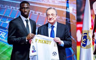 epa07657843 Real Madrid's new signing French player Ferland Mendy (L) poses with Real Madrid's President Florentino Perez during his presentation at Santiago Bernabeu stadium in Madrid, Spain, 19 June 2019. Mendy, 24, has signed a contract with the Spanish LaLiga club Real Madrid for the next six seasons.  EPA/Emilio Naranjo