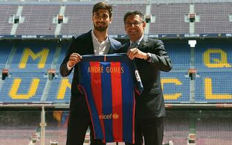 New Barcelona's Portuguesse forward Andre Gomes(L) poses with his new jersey beside Barcelona's president Josep Maria Bartomeu (R) on the pitch during his official presentation at the Camp Nou stadium in Barcelona on July 27, 2016, after signing his new contract with the Catalan club. / AFP / LLUIS GENE        (Photo credit should read LLUIS GENE/AFP via Getty Images)