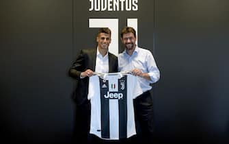 TURIN, ITALY - JUNE 27:  Juventus new signing Joao Cancelo poses with Juventus president Andrea Agnelli on June 27, 2018 in Turin, Italy.  (Photo by Filippo Alfero - Juventus FC/Juventus FC via Getty Images)