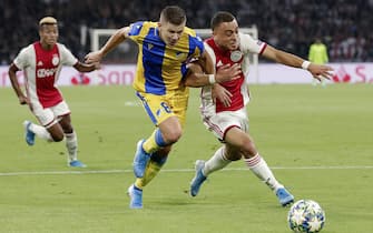 AMSTERDAM, NETHERLANDS - AUGUST 28: (L-R) Roman Bezjak of APOEL, Sergino Dest of Ajax  during the UEFA Champions League  match between Ajax v Apoel Nicosia at the Johan Cruijff Arena on August 28, 2019 in Amsterdam Netherlands (Photo by Erwin Spek/Soccrates/Getty Images)