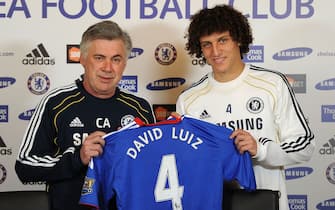 COBHAM, ENGLAND - FEBRUARY 11:  David Luiz of Chelsea is presented his shirt by Chelsea manager Carlo Ancelotti during a press conference at the Cobham training ground on February 11, 2011 in Cobham, England.  (Photo by Darren Walsh/Chelsea FC via Getty Images)