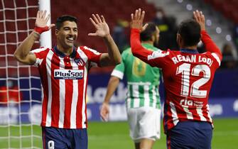 epa08771691 Atletico Madrid's Luis Suarez (L) celebrates with teammate Renan Lodi (R) after scoring the 2-0 lead during the Spanish La Liga soccer match between Atletico Madrid and Real Betis at Metropolitano stadium in Madrid, Spain, 24 October 2020.  EPA/Ballesteros