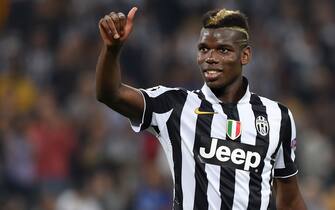 TURIN, ITALY - SEPTEMBER 16:  Paul Pogba of Juventus salutes the fans at the end of the UEFA Champions League Group A match between Juventus and Malmo FF on September 16, 2014 in Turin, Italy.  (Photo by Valerio Pennicino/Getty Images)