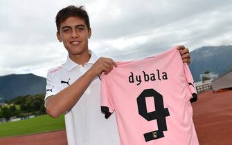 BOLZANO, ITALY - JULY 21:  Paulo Dybala shows his new shirt during his presentation as the club's new signing, after a US Citta di Palermo pre-season training session at Sport Well Center on July 21, 2012 in Malles Venosta near Bolzano, Italy.  (Photo by Tullio M. Puglia/Getty Images)