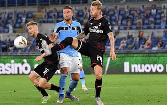 1224709127 ROME, ITALY - JULY 04: Sergei Milinkovic-Savic of SS Lazio competes for the ball with Alexis Saelemaekers and Simon Kjaer of AC Milan ,during the Serie A match between SS Lazio and AC Milan at Stadio Olimpico on July 4, 2020 in Rome, Italy. (Photo by MB Media/Getty Images)