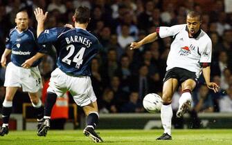 PEN03 - 20020423 - LONDON, UNITED KINGDOM : Fulham's French striker Steve Marlet (R) scores their second goal past Bolton defender Tony Barness 23 April 2002,  during their English Premiership relegation match at Craven Cottage. 
EPA PHOTO          EPA/GERRY PENNY/gp mda