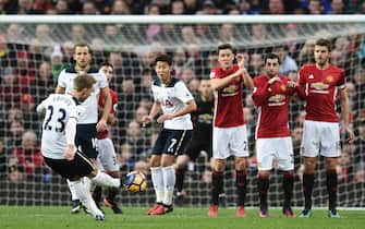 Tottenham Hotspur's Danish midfielder Christian Eriksen (L) takes a freekick during the English Premier League football match between Manchester United and Tottenham Hotspur at Old Trafford in Manchester, north west England, on December 11, 2016. / AFP / OLI SCARFF / RESTRICTED TO EDITORIAL USE. No use with unauthorized audio, video, data, fixture lists, club/league logos or 'live' services. Online in-match use limited to 75 images, no video emulation. No use in betting, games or single club/league/player publications.  /         (Photo credit should read OLI SCARFF/AFP via Getty Images)