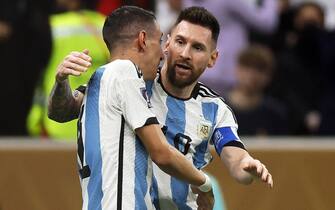 epa10372380 Lionel Messi (R) of Argentina celebrates with teammate Angel di Maria (L) after scoring the 1-0 lead from the penalty spot during the FIFA World Cup 2022 Final between Argentina and France at Lusail stadium in Lusail, Qatar, 18 December 2022.  EPA/Ronald Wittek